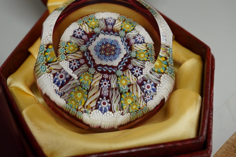 Two boxed Perthshire glass paperweights, the first faceted with latticino twists and complex canes, the second close packed millefiori paperweight, 62/400